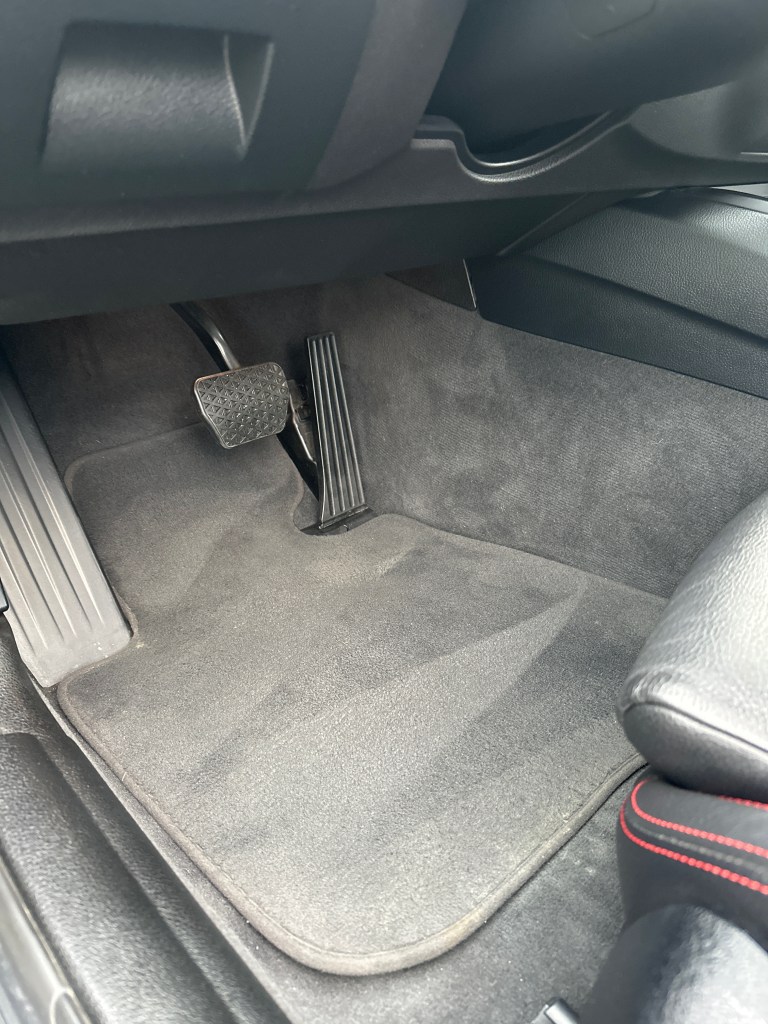 Deep-cleaned car floor mats and pedals after professional interior detailing by Dennis Auto Details. Expert mobile detailing services available.