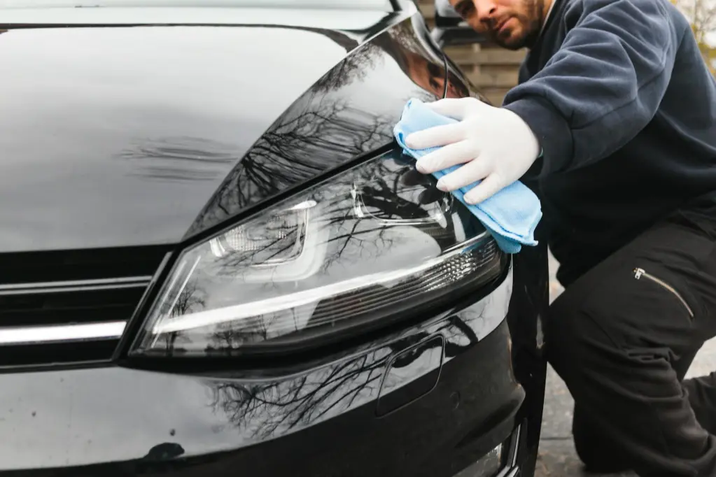 a man wiping a car