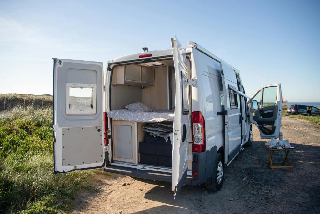 white van on brown dirt road