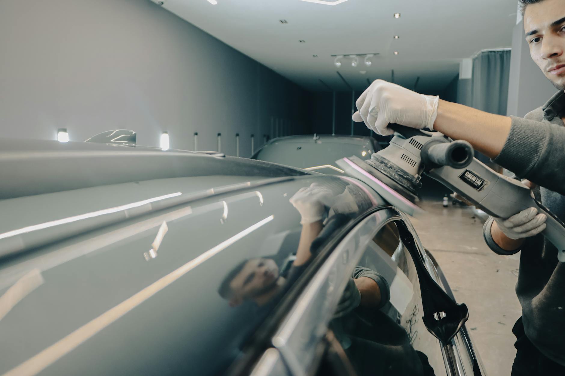 man polishing a car roof